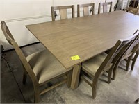 large dining table with 8 padded chairs