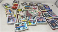 Multiple packs of sealed 1990s baseball cards