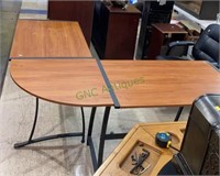 L shaped wood laminate desk with metal base.