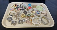Tray lot filled with a variety of costume jewelry