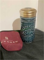 Chinese insulated tea or coffee mug with lid.