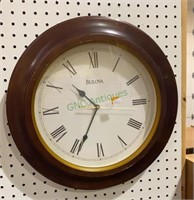 Bulova brand oval battery operated wall clock.