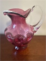 Hand blown cranberry glass pitcher applied handle