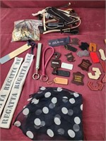 Broken belt pieces, tags from purses, belt buckle