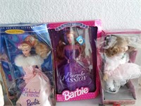 2 Barbies with baby doll in boxes