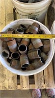 Bucket of pipe fittings