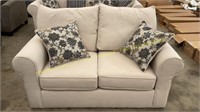 Cream Upholstered Loveseat w/ Floral Pillows