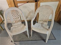Two modern outdoor plastic resin chairs.