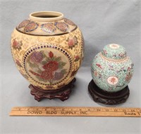 (2) Asian Inspired Vases/Jars on Carved Wooden