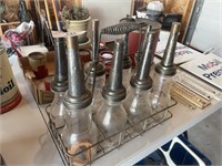 8 OIL BOTTLES AND METAL CARRIER