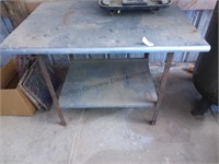 Metal table and tractor seat 42 in by 30 in about