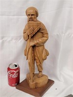 Wood carving man with wind instrument,  walking