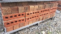 Pallet of red brick.  Bricks are approximately