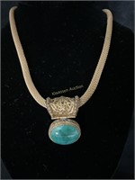 Malachite pendant on gold tone rope necklace