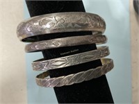 Embossed silver colored dangle bracelets