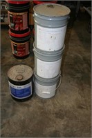 Four 5 gallon buckets of masonry sealer. One has