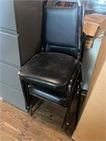 Lot of 2 black stack chairs worn
