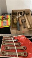 Safety vest, sunglasses, hammers, and tools
