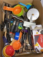 Box of kitchen utensils including pizza cutter,