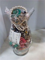 Vase full of assorted jewelry