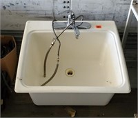 White fiberglass utility sink, faucet included