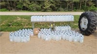 Large lot of hand sanitizer and 2-2'x4' SS tables
