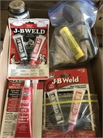 Tubes of J-B Weld black and red and other