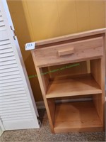 One drawer stand with shelves.