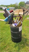 Barrel of yard and hand tools