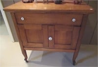 Wood cabinet on casters. Measures:  29" H x 30" W