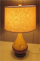 Art pottery lamp with shade and glass finial.