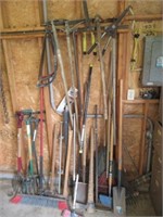 Assortment of yard tools including pitch fork,
