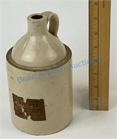 Antique stoneware whiskey jug with the original