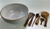 Unmarked crock bowl with various wooden utensils.