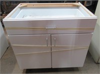 White 2 door/ 1 drawer cabinet. Measures 36" x