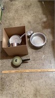 Various pots and pans in a box.