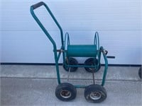 Green hose reel on cart
