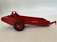 McCormick Deering metal toy tractor spreader