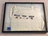 Framed Neeldework Apron, “Bills Toy Shop”