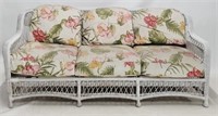 Wicker sofa, floral cushions