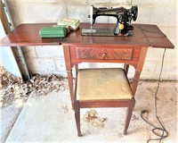 antique Singer sewing machine in cabinet