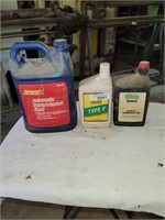 Assorted Jugs of Transmission Fluid - Partial Full