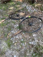 Two iron wheels (one is bent)