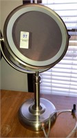 Lighted reversible makeup mirror