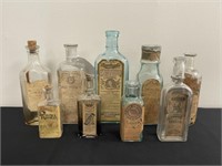 9 Antique Bottles w/ Paper Advertisements