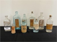 9 Antique Bottles with Paper Labels
