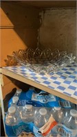 Shelf of glass bowl, plastic bins and tray