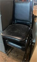 Lot of 4 black stack chairs worn stacking