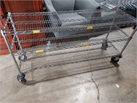 metal rack on wheels, bottom shelf bent - see pic