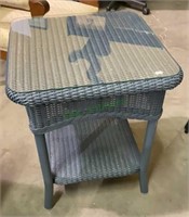 Wicker patio side table with glass table top.